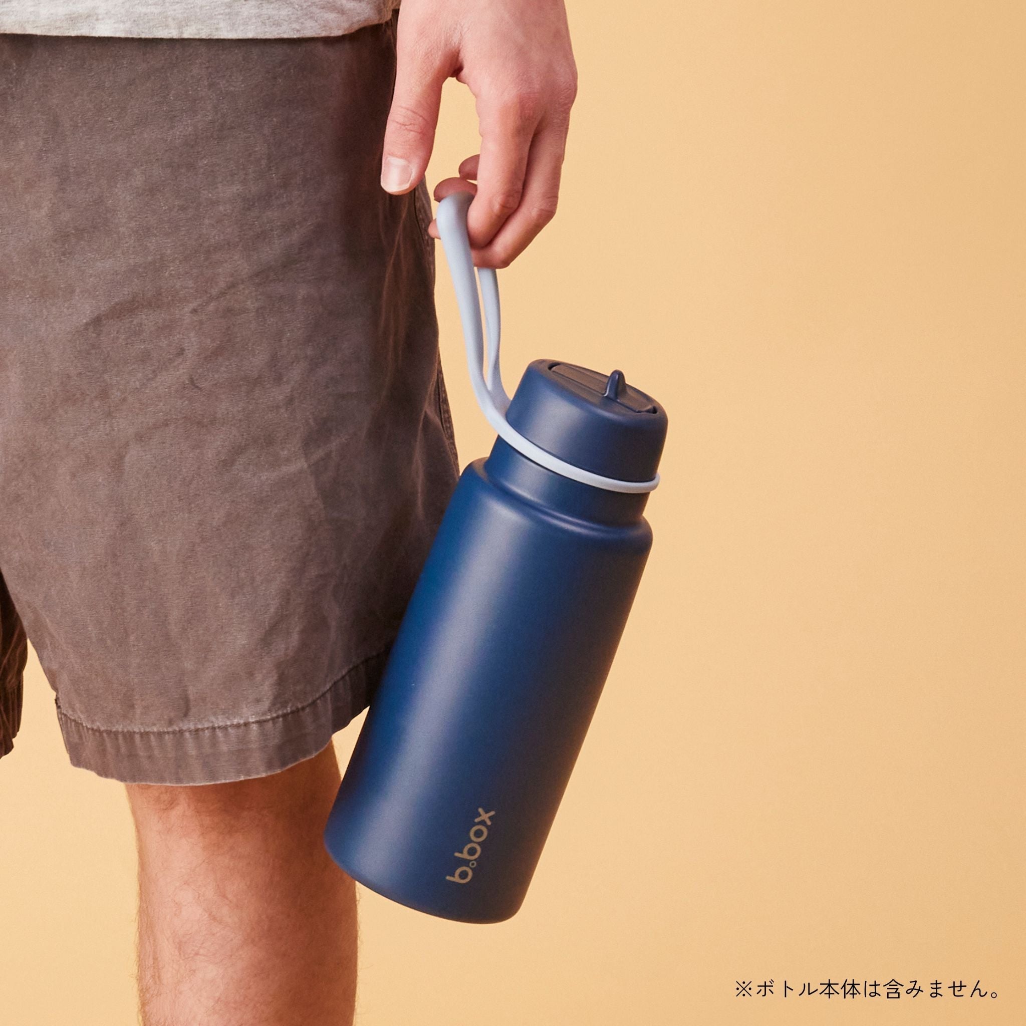 ビーボックスの大容量ボトル 紺色を手に持っている