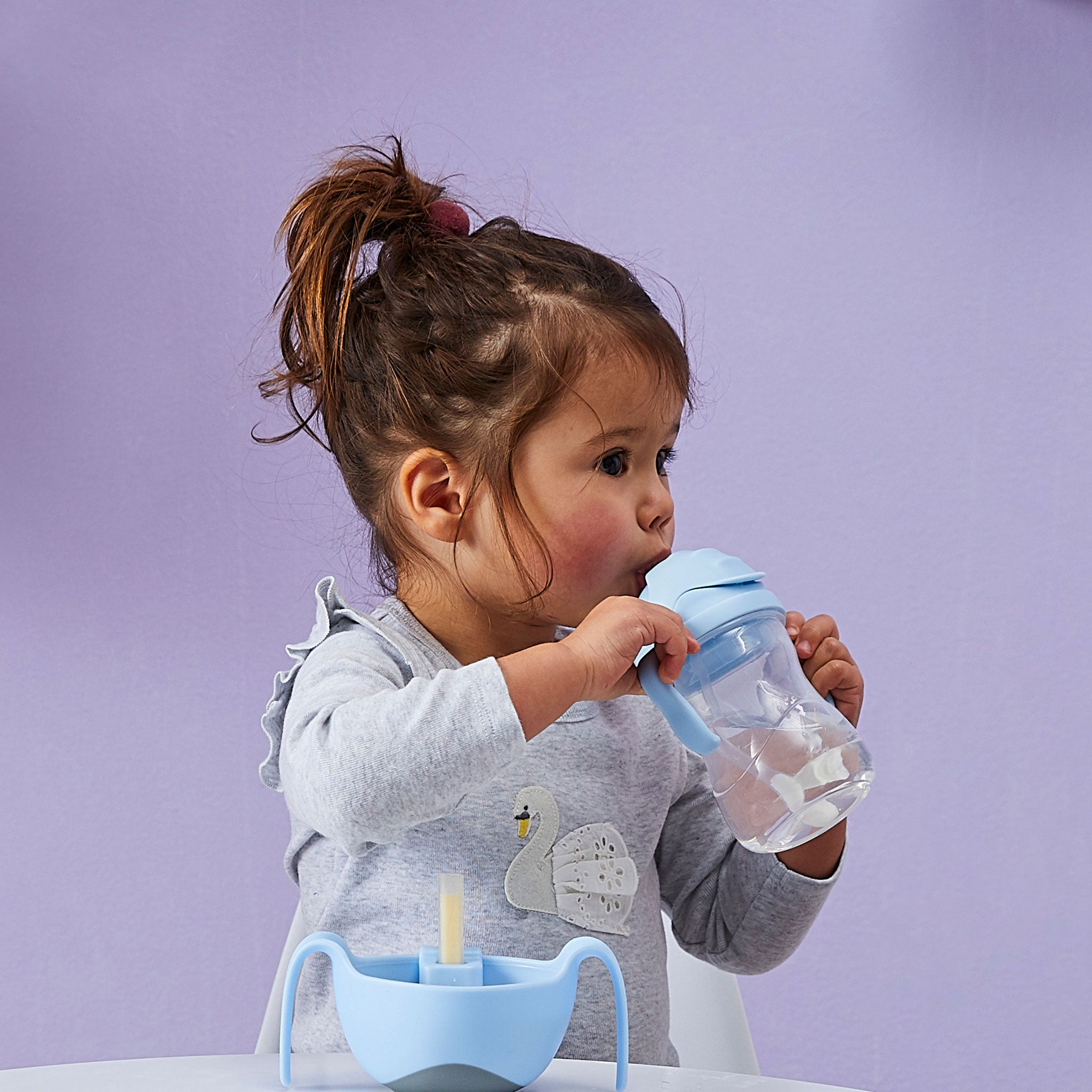 シッピーカップbubblegumを飲む女の子の赤ちゃん